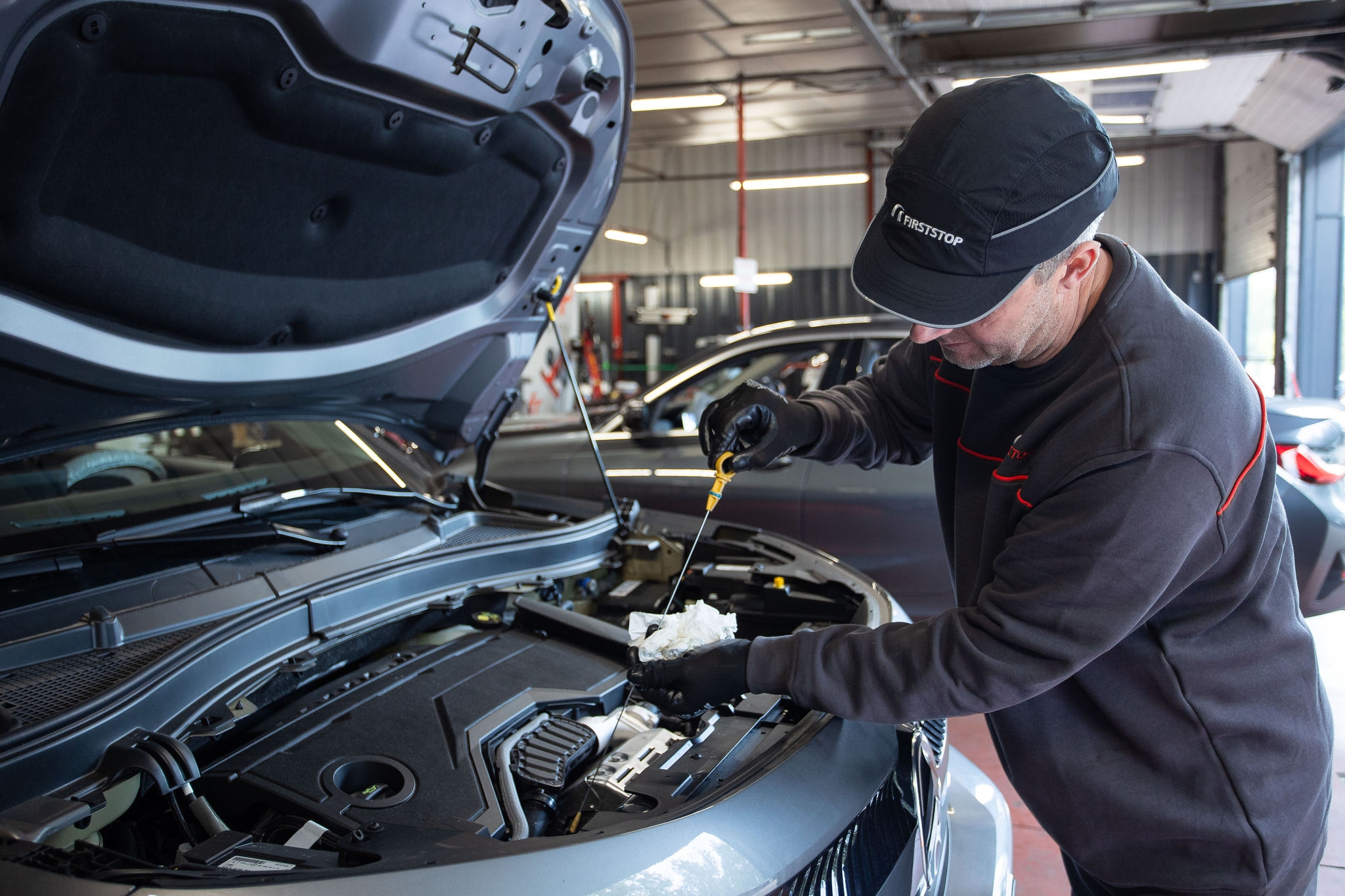 Tecnico effettua controllo olio motore auto