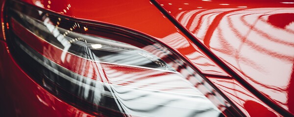 A close shot of an orange sports cars backlight
